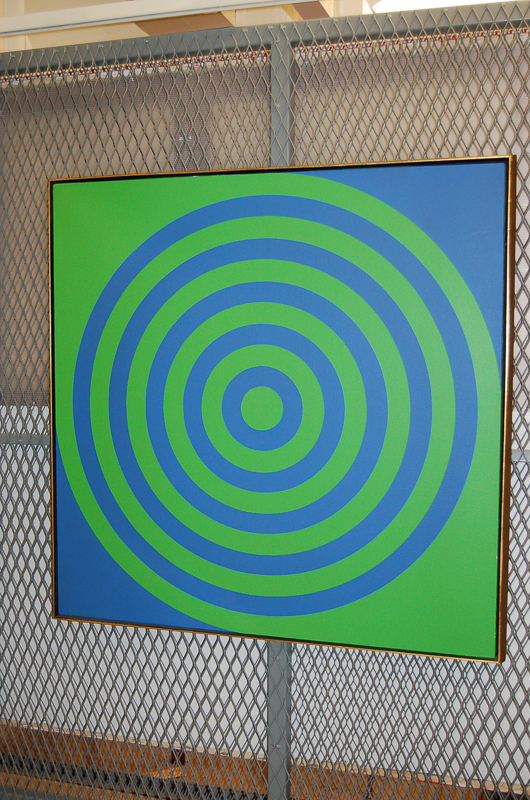 Square canvas with concentric circle in green and blue. Design gives the impression of the canvas rotating.