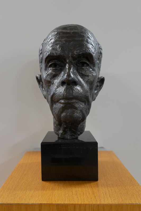 Bronze head of a balding older man.