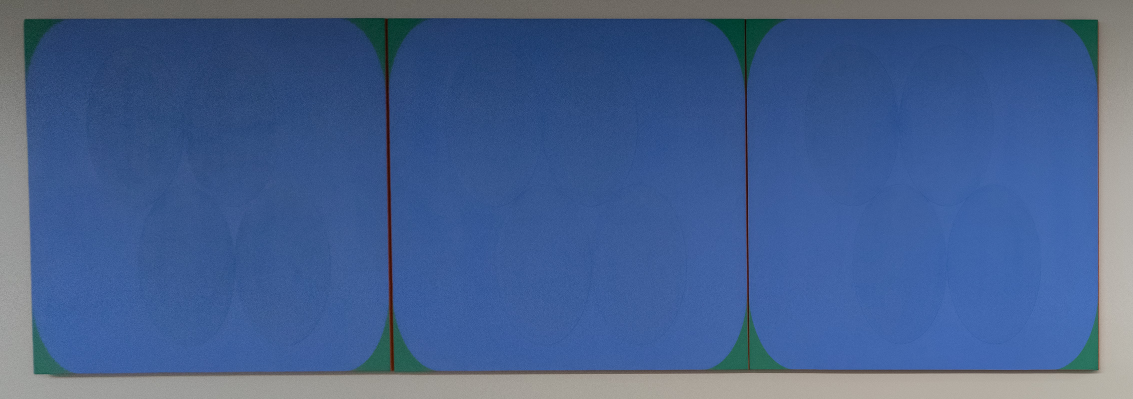Colourfield painting in three panels, primarily blue.