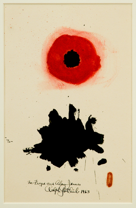 Red eye with black pupil overtop a black inksplotch, with dedication written in same ink.