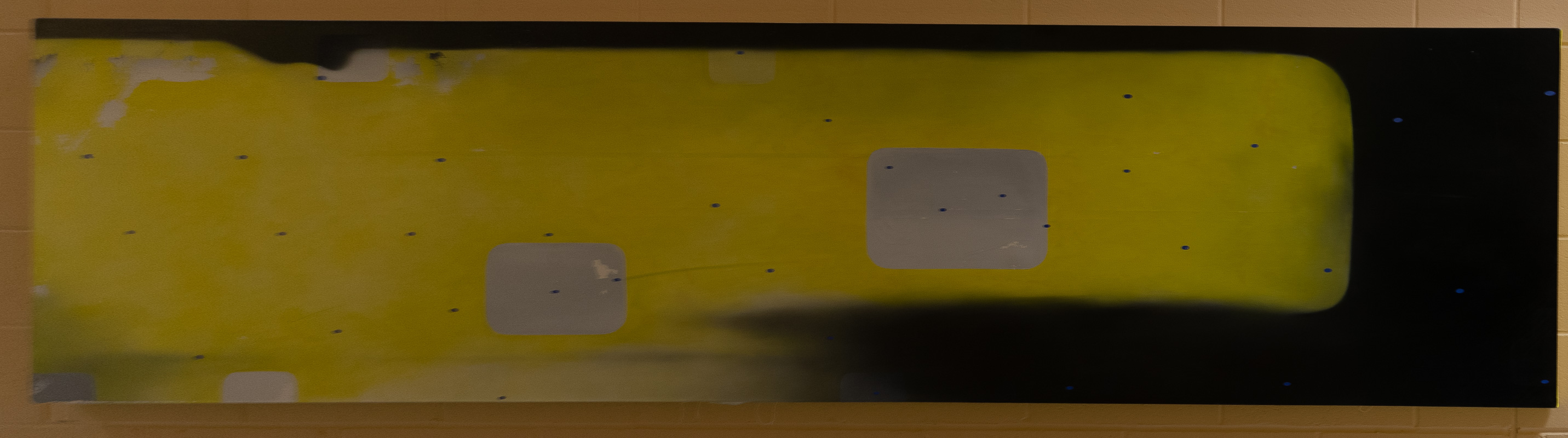 Long abstract painting, primarily yellow and black.