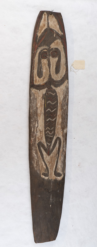 Tall skinny wooden board with stylized figure.