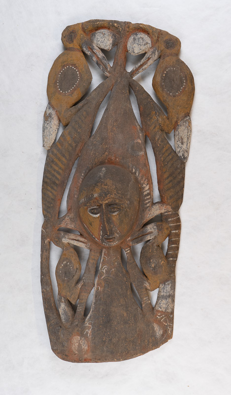 Carved wooden object with figure and plants.