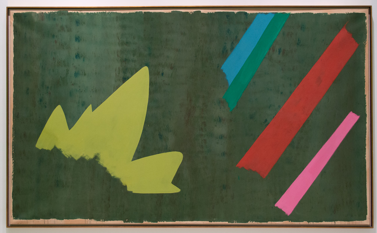 Large abstract canvas with a dark greenish background with a yellow starburst on the left and three stripes on the left. 